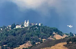 CLOSE CALL: A tanker helps fight the Chimney Fire from the air on Aug. 21, when the flames came within 3 miles of Hearst Castle. - PHOTO BY JAYSON MELLOM