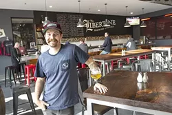 THIS GUY: People can keep taking his picture, but Libertine Brewing Company Head of Brewing Operations Tyler Clark aims to keep the spotlight on his wild ales—and even wilder vinyl collection—in play now at the brewery’s new Broad St. location. - PHOTO BY JAYSON MELLOM