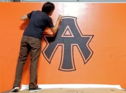A-TOWN DOWN!: Silas Corley hand paints the A-Town logo for the skate park in Atascadero. His work was recently featured on the cover of the city’s summer 2016 recreation guide. - PHOTO COURTESY OF SILAS CORLEY