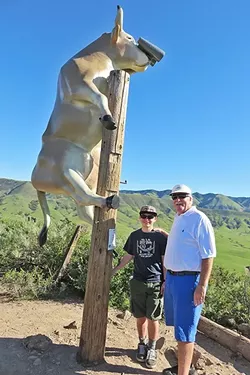 COUNTY ADVENTURE: Bruce Brandenburg and his “little brother” Shane Blume pose with cow No. 87, “Moo with a view,” while on their quest to visit all 101 cows in CowParade SLO County. - PHOTO COURTESY OF BRUCE BRANDENBURG