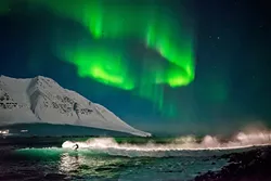 SURREAL: While Chris Burkard and company were forced out of one surf spot in Iceland by a storm, they did manage to catch some waves under the famous Northern Lights while filming 'Under an Arctic Sky.' - PHOTO COURTESY OF CHRIS BURKARD