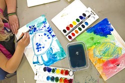 ARTIST IN TRAINING:  Veda Baker, a first grader at Virginia Peterson Elementary School in Paso Robles, takes her time painting the ocean backdrop of her crab painting at an art class at Studios on the Park. - PHOTO BY JAYSON MELLOM