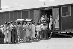 RATIONS:  People wait in line for lunch outside the mess hall at the internment camp at Manzanar in 1942. - PHOTO COURTESY OF THE NATIONAL ARCHIVES AND RECORDS ADMINISTRATION