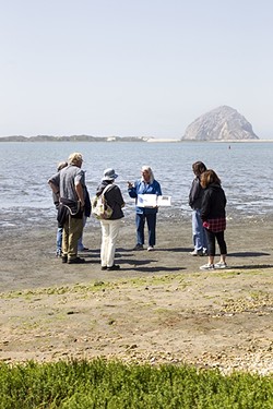 ADULT LEARNING:  Morro Bay State Park docent Faylla Chapman uses her binder full of maps, diagrams, and fun facts to educate people about the history of Morro Bay, changes to the estuary, and all the things that call it home. - PHOTO BY JAYSON MELLOM