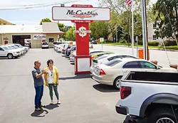 CARS FOR DAYS : McCarthy’s salesman Mike Estes talks with customer Shelly Kubel on the lot in SLO. New Times readers voted the company as SLO County’s Best Used Car Dealer for the ninth year in a row. - PHOTO BY JAYSON MELLOM