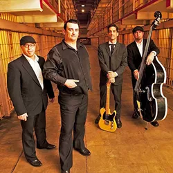 PRISON BLUES: Johnny Cash tribute act Cash’d Out, here posing at Alcatraz, brings the vibe of Cash’s Folsom Prison and San Quentin live albums to their show at Tooth & Nail on May 14. - PHOTO COURTESY OF CASH’D OUT