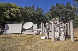 ROAD LESS TRAVELED Twenty-something artist and musician Dr. Isapony XD built what he calls his "time machine"—all sourced from discarded electronics and building materials—in the backyard of his Atascadero rental, where he screens movies and hosts concerts. - PHOTO BY JAYSON MELLOM