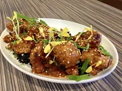 DON'T MISS THE MEAT Korean heirloom cauliflower wows with black rice, sesame, and gold pea shoots. - PHOTO BY REID CAIN