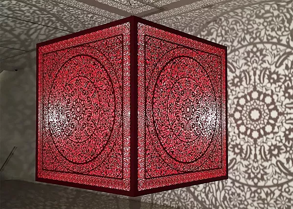 IMMERSIVE A single bulb in artist Anila Quayyum Agha's installation piece on display at Cuesta College's Harold J. Miossi Gallery reflects an intricate pattern onto the walls and floor. - PHOTO COURTESY OF THE HAROLD J. MIOSSI GALERY