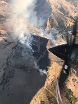 TOO CLOSE FOR COMFORT The "Poly Fire" started around 3:30 p.m. on Sept. 26, igniting above the "P" on the hillside above Cal Poly. - PHOTO COURTESY OF CAL FIRE SLO