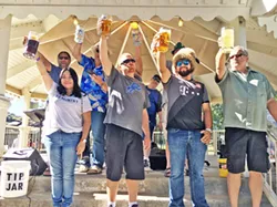 RAISE A GLASS! Stein hoisting contestants show off their arm strength for the crowd at Oktoberfest in Templeton. The rules are simple: take a full stein, lock your elbow, and hold it at shoulder height for as long as you can! - PHOTO BY SINÉAD SCHOUTEN