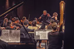A NIGHT OUT Scott Yoo conducts the Festival Mozaic Orchestra earlier this year at Cuesta College's Cultural and Performing Arts Center. The festival was one of 28 organizations to participate in the Arts and Economic Prosperity 5 Survey, which revealed that nonprofit arts are a $27 million industry in SLO County. - PHOTO COURTESY OF KATY BARNARD