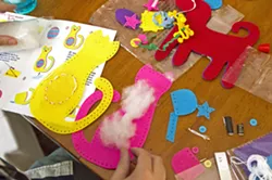 STUFFING ANIMALS With the My First Sewing Kit, all you have to do is pull out a little stuffing, grab a cat cutout, and put the thread through the needle. - PHOTO BY JAYSON MELLOM