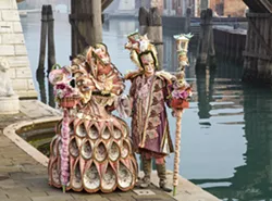 DETAILS From the teapot on top of the lady's staff to the birdhouse on top of the gentleman's there are endless details to pick out in Cheryl Strahl's delightful photo of this pink-clad Carnevale couple. - PHOTO COURTESY OF CHERYL STRAHL