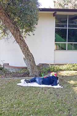 RESTING A man sleeps in downtown San Luis Obispo. - PHOTO BY JAYSON MELLOM