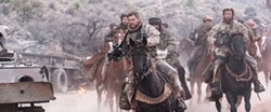 WAR In the aftermath of 9/11, Capt. Mitch Nelson (Chris Hemsworth, left) leads a U.S. Special Forces team into Afghanistan on a dangerous mission in 12 Strong. - PHOTO COURTESY OF WARNER BROS. PICTURES