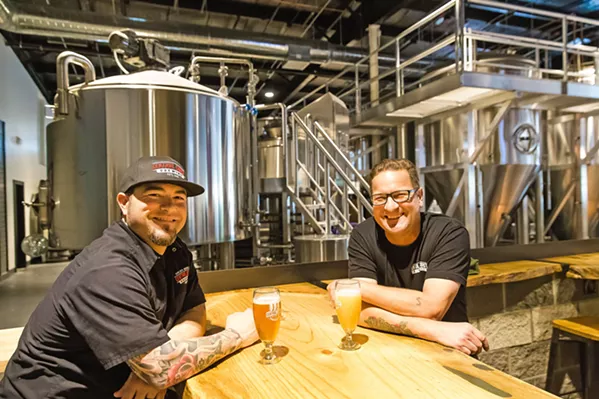 WAKING DREAM After two years of dreaming and scheming, a cold one is in order. From left, Central Coast Brewing Company Brewmaster Brendan Gough and Sales Manager Stormy Trevino share a celebratory sip at the new 6 Higuera St. location, which opened to massive fanfare last month. - PHOTO BY JAYSON MELLOM