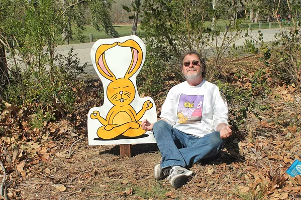 ZEN Cartoonist Leigh Rubin relaxes with his creation Lounging Bunny at the SLO Botanical Garden. - PHOTO COURTESY OF LEIGH RUBIN