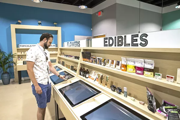 MOD SHOP 805 Beach Breaks Manager Daniel Fried demos the RFID screens that will tell customers about the product they are scanning. The high tech cannabis retailer will be the first dispensary to open its doors in Grover Beach on May 19. - PHOTO BY JAYSON MELLOM