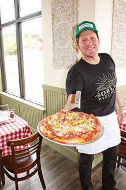 SINCE 1973 Ryan Delmore of Del's Pizzeria and his brother Darren grew up in the pizza business and have yet to change their popular family recipes. Now, 45 years after first opening, the family invites folks to check out a brand new location at 1101 Price St., suite 100. - PHOTO BY HAYLEY THOMAS CAIN