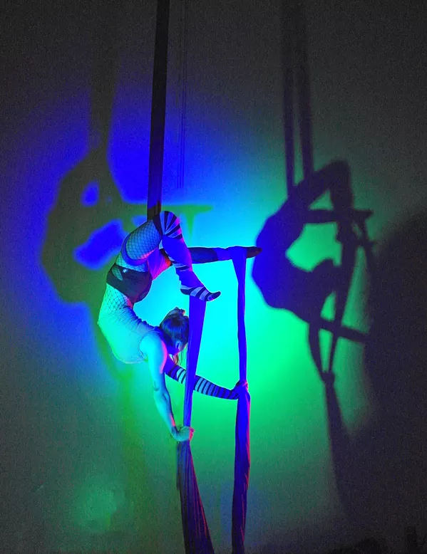 CREEPY CRAWLY Nikki Pesce, an aerialist at Levity Academy, contorts and arches her back while hooking onto the aerial silks. - PHOTO COURTESY OF LEVITY ACADEMY