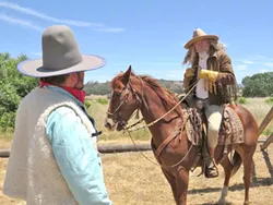 TO THE RESCUE Buffalo Bill (Ted Levine, right) speaks to Sheriff Jesse (Billy Moen) after the missing cows are located. - PHOTO COURTESY OF SEAN MCALPINE