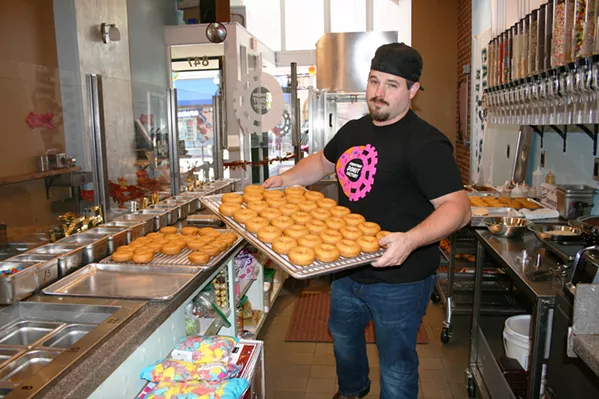 DOLLARS TO DOUGHNUTS You've got to wake up pretty early to beat Downtown Donut Company owner Josh Morrow to work. He's always up bright and early with "doughnut chemist" Sam Lopez, churning out dozens of moist cake donuts, which serve as blank canvases for the day's DIY doughnut creations. - PHOTO BY HAYLEY THOMAS CAIN