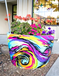 COMMUNITY ART The colorful wine barrel flower planter in front of the Laure Carlisle Art Studio &amp; Gallery is one of about 100 planters decorated by local artists that will adorn the downtown Paso Robles area. - PHOTO BY JAYSON MELLOM