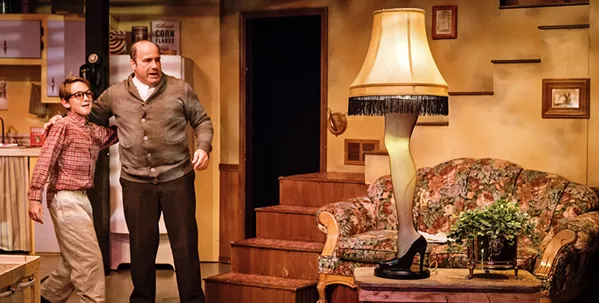FRAGILE Ralphie (Coen Carlberg, left) is in awe as his father (Seth Blackburn) unpacks his "award" from a contest, the highly controversial leg lamp, in A Christmas Story. - PHOTO COURTESY OF RYLO MEDIA DESIGN