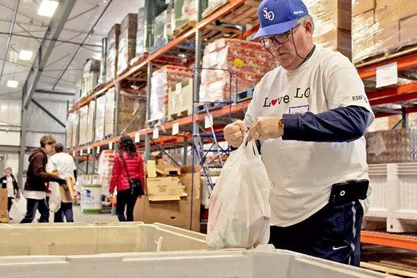 MEETING A NEED A SLO Food Bank volunteer packages one of the organization’s no-cook food bags for SLO County’s homeless population. More than 30 groups, including the SLO Police Department’s Community Action Team, hand out the bags on a daily basis. - PHOTO COURTESY OF THE SLO FOOD BANK