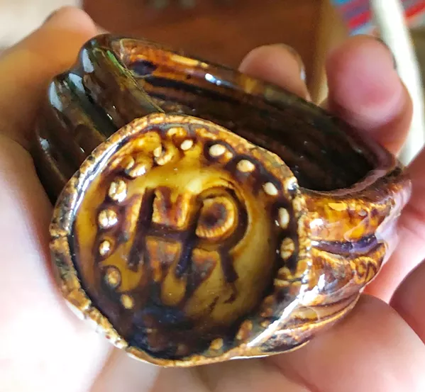 STAY CLASSY This handmade ceramic napkin ring—made by the bride's dad, Darren Thomas of Atascadero, features bride and groom Hayley and Reid Cain's initials stamped on the front. - PHOTO COURTESY OF HAYLEY CAIN
