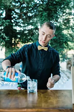 FAMILY THAT POURS One of best parts of Joslin's job is creating a bartending family that love to work with one other and interact with wedding attendees such as Luke Wills (pictured). - PHOTO COURTESY OF LEANA MYRA PHOTOGRAPHY