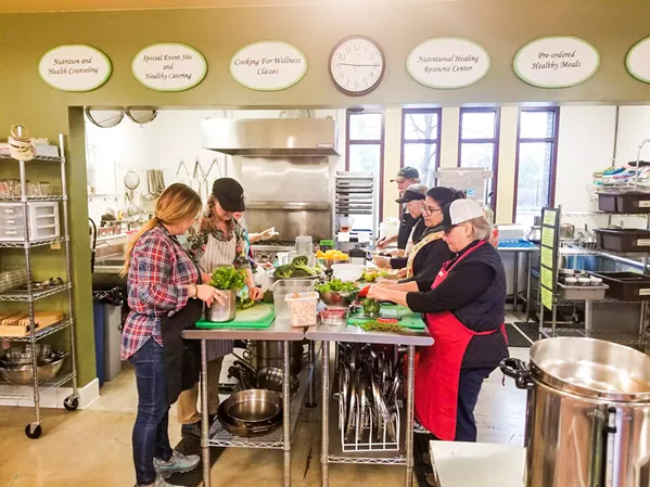 COOK IT UP Volunteers prep food in Templeton again after spending three months using the Atascadero Bible Church's kitchen to keep the nonprofit delivering food to its members. - PHOTO COURTESY OF THE WELLNESS KITCHEN