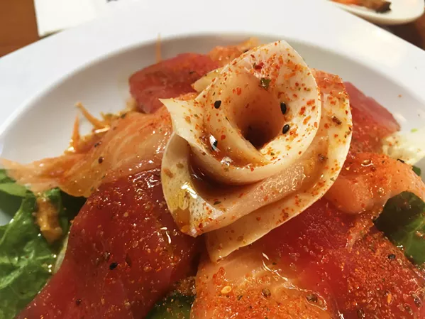 JAPANESE CEVICHE Fresh, soft, and succulent sashimi slices of tuna, salmon, and yellowtail are served over a bed of lettuce and drizzled with a cilantro chili sauce that's a little bit spicy and a lotta bit good. - PHOTO BY CAMILLIA LANHAM
