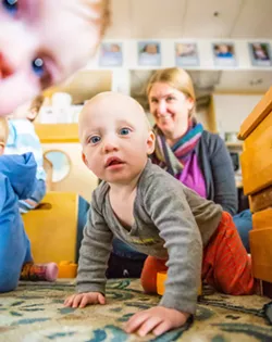 CARE WANTED Nova, who attends the Cal Poly ASI Children's Center, appears intrigued by New Times photographer Jaysom Mellom. Infant care is an often unmet and rapidly growing need in SLO County. - PHOTOS BY JAYSON MELLOM
