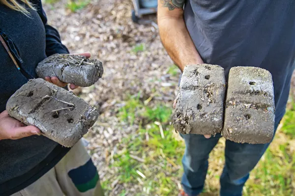 TESTING, TESTING Cobber's often work with materials found on-site to craft the compound that will eventually build the structure. These bricks are one way of testing the composite for strength. Each is made up with different ratios of soil, sand, and straw. - PHOTO BY JAYSON MELLOM