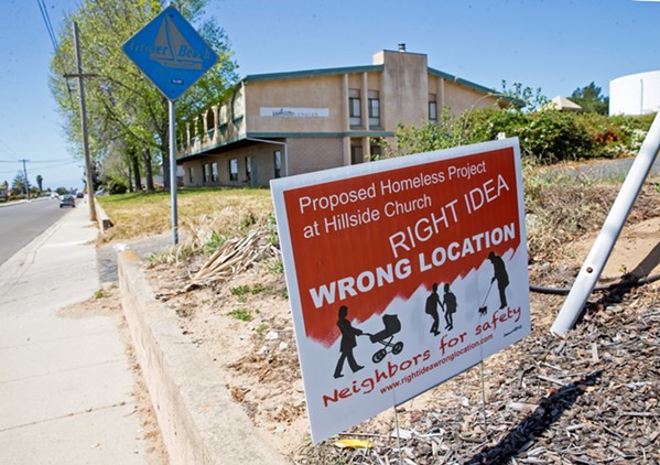 RIGHT IDEA, WHICH LOCATION? Plans for low-income housing and a homeless services complex at Hillside Church in Grover Beach face strong resistance from neighboring residents, who have taken to yard signs to express their opposition. - PHOTO BY JAYSON MELLOM