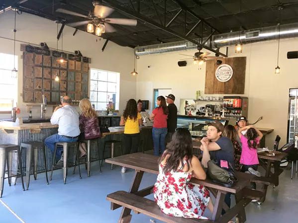 GAS UP The Colony Market and Deli's bar and countertop sit inside the garage doors where an auto shop used to be. - PHOTO BY CAMILLIA LANHAM