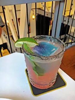 UNICORN FOUND Unicorn Paloma is one of many fab cocktails on the drink menu. This magical Patron Silver grapefruit cocktail is chilled with a butterfly tea ice cube and rimmed in pink and black salt. - PHOTOS BY BETH GIUFFRE