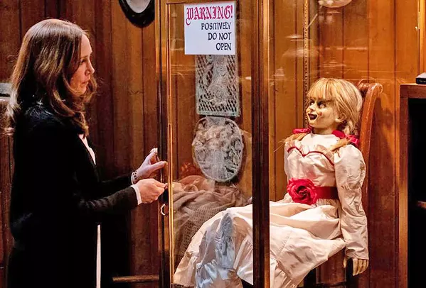 BREAK GLASS FOR SCARES! Demonologist Lorraine Warren (Vera Farmiga) thinks she's got possessed doll Annabelle locked safely away, but soon the doll is after her daughter, in Annabelle Comes Home. - PHOTO COURTESY OF NEW LINE CINEMA