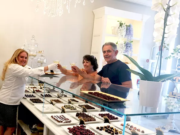 LIVING IT UP Locals Andrea and Randy Chavez decide to stop by Sheila Kearns Chocolate & Confections after a downtown matinee, on their way to the bookstore. Andrea is a big fan of Sheila's Cabernet Sea Salt Caramels, and Randy likes to try all the gluten-free bites. - PHOTO BY BETH GIUFFRE