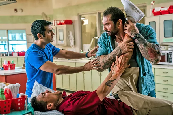 BUDDY FLICK Mild-mannered Uber driver, Stu (Kumail Nanjiani, left), tries to temper his hard-nosed detective passenger, Vic (Dave Bautista, right), as they work together to track down a terrorist, in the comedy action film Stuber. - PHOTO COURTESY OF TWENTIETH CENTURY FOX