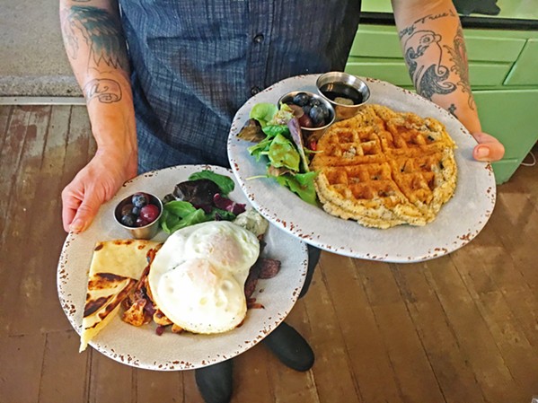 WAFFLES AND EGGS PLEASE Chef Taryn Bauer runs two plates she just cooked up: harissa hash and eggs and a lemon poppyseed waffle. - PHOTOS BY BETH GIUFFRE