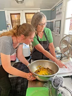 OFFICE MANAGER EXTRAORDINAIRE Office Manager Terri Knowlton (right)makes fig chutney with intern Maggie. Knowlton is in charge of Fig's community outreach, networking, program and event coordinating, and more. She's known at Fig as the person who connects the dots to make it all happen. - PHOTO COURTESY OF CHRISTINA DILLOW