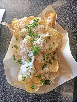 THE USS INDEPENDENCE Nachos at Chipwrecked are all potato chips, whimsically named after ships. This aircraft carrier comes with fresh garlic, parsley, parmesan, and a hint of lemon. - PHOTOS BY BETH GIUFFRE