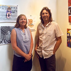 ART FROM THE SOURCE Justice in Justice curators Heather and Kevin Mikelonis stand with a favorite piece of theirs by artist Hugo Gonzalez. Gonzalez's work was discovered through Barrios Unidos, an organization dedicated to providing re-entry opportunities to former prisoners. - PHOTOS BY MALEA MARTIN