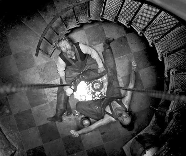 MADNESS Wake (Defoe, left) and Winslow (Pattinson) take to drink and soon are at odds in this hallucinatory tale of deprivation, isolation, and power. - PHOTOS COURTESY OF A24
