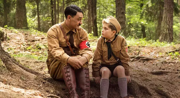 MENTOR? Imaginary friend, "Adolf" (writer-director Tailka Waititi), counsels Jojo (Roman Griffin Davis), a Nazi-in-training who's worried that his mother is hiding a Jew, in the satire Jojo Rabbit. - PHOTO COURTESY OF PIKI FILMS