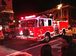 SPREADING CHEER On top of working most holidays, SLO County firefighters typically decorate their engines and ride in the annual Christmas parade. - PHOTO COURTESY OF SLO COUNTY FIRE DEPARTMENT