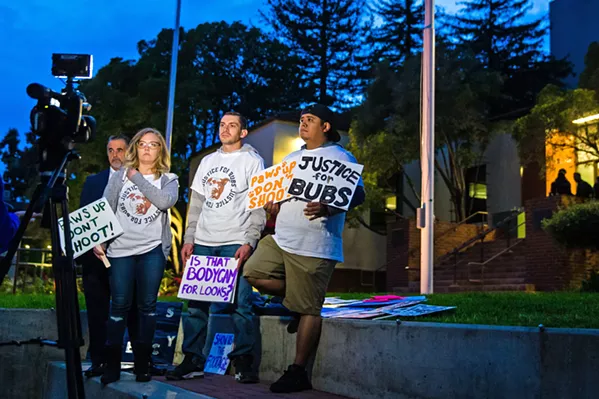 PROTESTING Nick Regalia (center right) and Riley Manford (center left) protest their dog's killing outside SLO City Hall on Dec. 3. They're demanding that the city release the body camera footage of the officer who shot it, and that he lose his badge as a consequence. - PHOTO BY JAYSON MELLOM